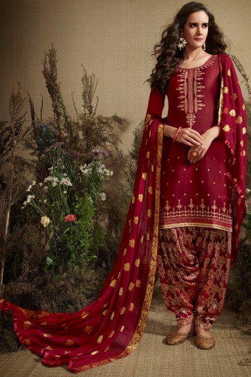 Pleasing Embroidered And Jacquard Work Maroon Silk Patiala Suit With Nazmin Dupatta